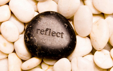 Stone with words Reflect